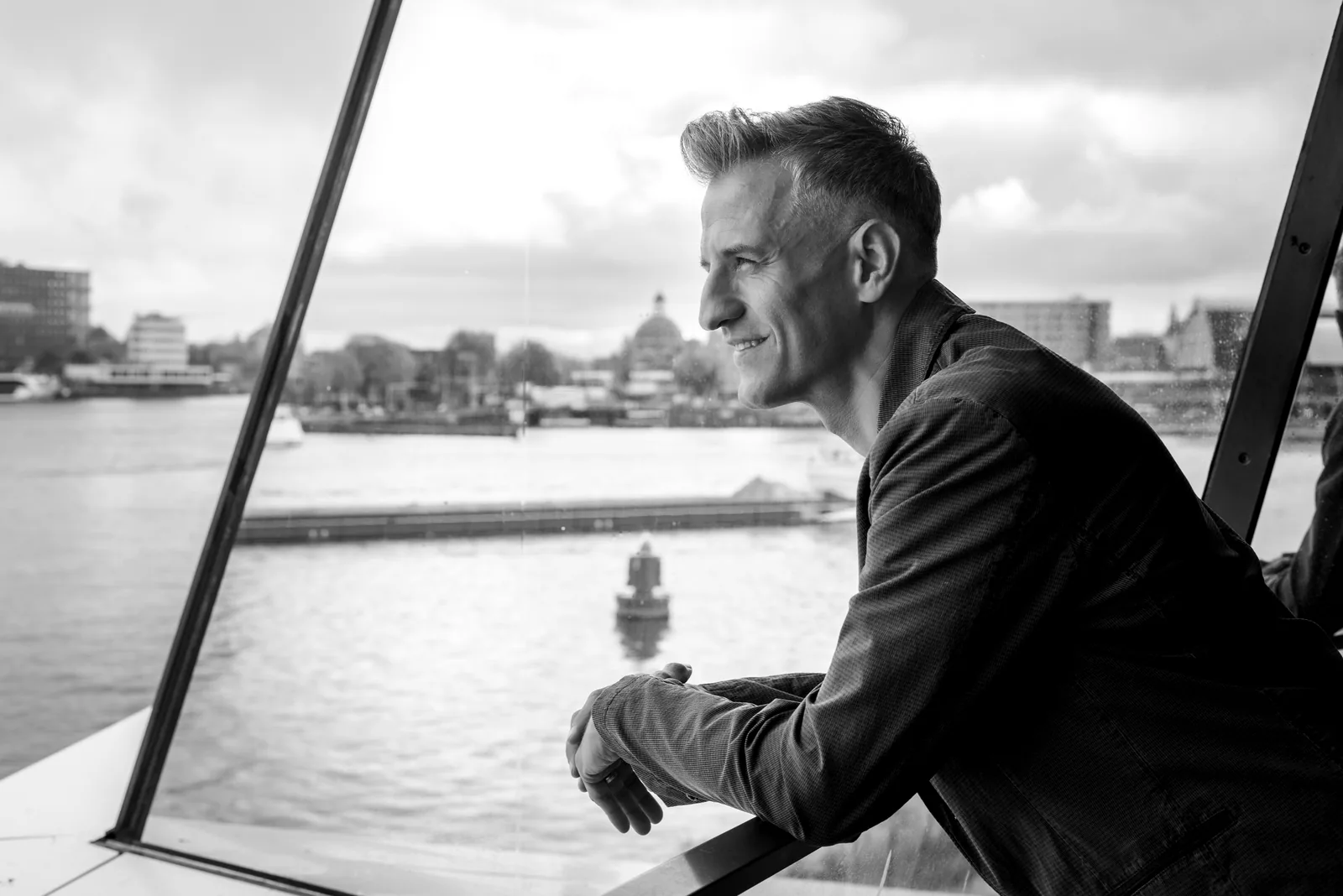 Vedran by a window, looking out over the water